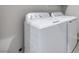 Laundry room complete with a white washing machine and dryer set against a neutral wall at 11922 Glide Reflection Ave, Las Vegas, NV 89138