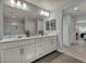 Bathroom with double sinks, large mirror, and shower with glass door, tiled floors, and modern vanity at 12290 Terrace Verde Ave, Las Vegas, NV 89138