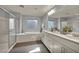 Bathroom featuring a soaking tub, glass shower, double vanity with marble countertop, and modern fixtures at 12290 Terrace Verde Ave, Las Vegas, NV 89138