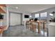 Spacious bonus room with modern tile flooring and an expansive table for work or hobbies with great natural light at 12290 Terrace Verde Ave, Las Vegas, NV 89138