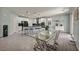 Modern dining area featuring a glass table and a view of the bright and modern kitchen at 12290 Terrace Verde Ave, Las Vegas, NV 89138