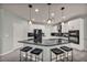 Well-appointed kitchen with stainless steel appliances, a black countertop island, and sleek cabinetry at 12290 Terrace Verde Ave, Las Vegas, NV 89138