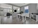 Spacious living room with a desk, wood-look tile floors, and plenty of natural light at 12290 Terrace Verde Ave, Las Vegas, NV 89138