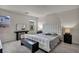Bedroom with a white tufted headboard, modern furniture, and gray wood-look flooring at 12290 Terrace Verde Ave, Las Vegas, NV 89138
