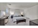 Bedroom with a white tufted headboard, gray wood-look flooring, and dual closets at 12290 Terrace Verde Ave, Las Vegas, NV 89138