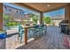 Inviting covered patio featuring a dining area and outdoor grill, perfect for entertaining at 12290 Terrace Verde Ave, Las Vegas, NV 89138