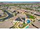 Gorgeous aerial view showcasing the beautiful home with a pool, firepit, solar panels, and surrounding neighborhood at 129 Major Bowling Pl, Henderson, NV 89011