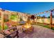 Inviting backyard with a fire pit, string lights, and swing benches at 129 Major Bowling Pl, Henderson, NV 89011
