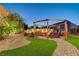 Charming backyard with a swing set patio, lush landscaping and space for outdoor enjoyment at 129 Major Bowling Pl, Henderson, NV 89011