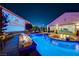 Stunning backyard pool area with outdoor movie screen, fire features, and spacious patio for entertaining at 129 Major Bowling Pl, Henderson, NV 89011