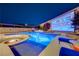 Backyard pool with a hot tub, fire pit, movie screen, and landscaped seating area at 129 Major Bowling Pl, Henderson, NV 89011