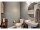 Powder room featuring a vessel sink, gray textured walls, and decorative floor tiles at 129 Major Bowling Pl, Henderson, NV 89011