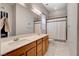 Bright bathroom featuring double sink vanity, large mirror, and shower-tub combo with white tiling at 129 Major Bowling Pl, Henderson, NV 89011