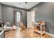 Versatile bedroom/flex space with gray walls, light colored wood flooring, window and rocking chair at 129 Major Bowling Pl, Henderson, NV 89011