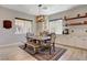 Dining area featuring a rustic table and chairs complemented by a decorative area rug at 129 Major Bowling Pl, Henderson, NV 89011