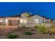 Charming single-story home with a tile roof, three-car garage, and manicured landscaping at 129 Major Bowling Pl, Henderson, NV 89011