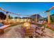 Inviting backyard with swing set patio, fire pit, and outdoor seating for relaxing evenings at 129 Major Bowling Pl, Henderson, NV 89011