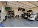 Spacious three car garage with epoxy floors, storage racks, and an electric vehicle charging port at 129 Major Bowling Pl, Henderson, NV 89011