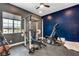 Bright home gym with weight rack, bench, weights, and cardio machine, with view from the window at 129 Major Bowling Pl, Henderson, NV 89011