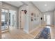 Spacious hallway with light wood floors, light gray walls, and access to various rooms including an office at 129 Major Bowling Pl, Henderson, NV 89011
