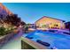 Outdoor space with a hot tub, fire pit, and seating area, ideal for relaxation and entertainment at 129 Major Bowling Pl, Henderson, NV 89011