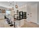 Stylish kitchen featuring a large center island with bar stools, custom white cabinetry and stainless appliances at 129 Major Bowling Pl, Henderson, NV 89011