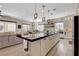 Spacious kitchen features a large center island with bar seating and a connecting living area at 129 Major Bowling Pl, Henderson, NV 89011