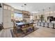 Dining area with a rustic wooden table and bench seating located next to the open concept kitchen at 129 Major Bowling Pl, Henderson, NV 89011