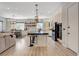 Open-concept kitchen with white cabinetry, large island with bar seating and modern appliances at 129 Major Bowling Pl, Henderson, NV 89011