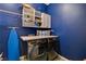 Well-lit laundry room with modern washer and dryer, plus ample storage for laundry supplies at 129 Major Bowling Pl, Henderson, NV 89011