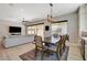 Open-concept living and dining area with views of the backyard pool and comfortable seating at 129 Major Bowling Pl, Henderson, NV 89011