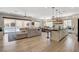 Open-concept living space with access to a modern kitchen and a sliding glass door to the pool area at 129 Major Bowling Pl, Henderson, NV 89011