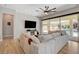 Inviting living room with a large sectional sofa, sliding glass doors and pool views at 129 Major Bowling Pl, Henderson, NV 89011