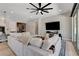 Spacious living room with a comfortable sectional sofa and a large sliding glass door to patio at 129 Major Bowling Pl, Henderson, NV 89011