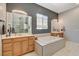 Relaxing main bathroom displaying a soaking tub, double sink vanity, and a separate glass shower at 129 Major Bowling Pl, Henderson, NV 89011