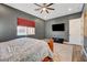 Spacious main bedroom with a large bed, a TV, and ample natural light from the window at 129 Major Bowling Pl, Henderson, NV 89011