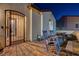 Enclosed patio with a wrought-iron gate, picnic table, and rocking chairs at 129 Major Bowling Pl, Henderson, NV 89011