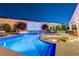 Gorgeous backyard pool area with a fire pit, waterfall feature, and an outdoor theater at 129 Major Bowling Pl, Henderson, NV 89011