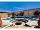 Bright pool area with a sunken fire pit, hot tub, and unique water features for outdoor enjoyment at 129 Major Bowling Pl, Henderson, NV 89011