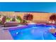 Backyard pool and spa with waterfall, spa, and fire feature for a relaxing ambiance at 129 Major Bowling Pl, Henderson, NV 89011