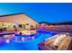 Inviting outdoor pool area with a fire pit, lighting, and ample space for entertaining guests at 129 Major Bowling Pl, Henderson, NV 89011