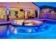Gorgeous pool and fire pit area, illuminated for evening enjoyment and relaxation at 129 Major Bowling Pl, Henderson, NV 89011