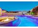Stunning pool at dusk with water features, fire pit, and ambient lighting for evening enjoyment at 129 Major Bowling Pl, Henderson, NV 89011
