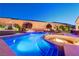 Backyard with a pool, sunken fire pit, and jacuzzi creating a perfect retreat for outdoor enjoyment at 129 Major Bowling Pl, Henderson, NV 89011