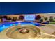 Backyard pool with a built-in fire pit, a waterfall feature, and an outdoor movie screen at 129 Major Bowling Pl, Henderson, NV 89011