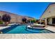 Resort-style pool with spa, waterfall feature, and ample seating for outdoor entertaining at 129 Major Bowling Pl, Henderson, NV 89011