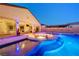 Backyard with an inviting pool, sunken fire pit, and landscaped surroundings creating an oasis at 129 Major Bowling Pl, Henderson, NV 89011
