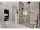 Modern bathroom showcasing a walk-in shower with glass enclosure and chevron patterned accent wall at 129 Major Bowling Pl, Henderson, NV 89011