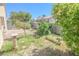 Large backyard area featuring desert landscaping, potted plants, and brickwork at 1349 Goldenglow Rd, Las Vegas, NV 89108