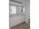 Functional bathroom with vanity, ample cabinet space, large mirror, and neutral flooring at 1349 Goldenglow Rd, Las Vegas, NV 89108
